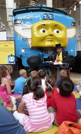 Sir Topham Hatt, The Fat Controller telling a story in front of D199.